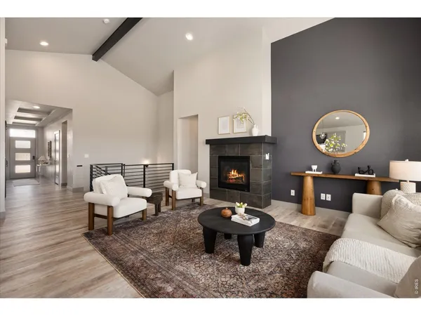 a living room with stainless steel appliances kitchen island furniture and a view of kitchen