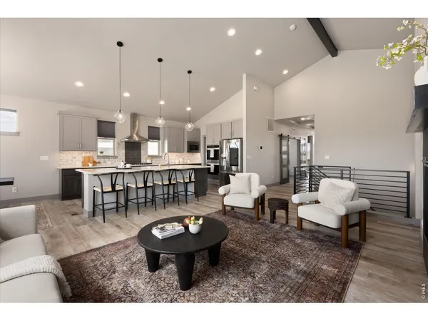 a kitchen with stainless steel appliances granite countertop a kitchen island hardwood floor sink stove dining table and chairs