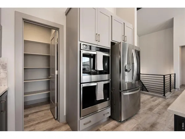 a kitchen with stainless steel appliances a sink stove and cabinets