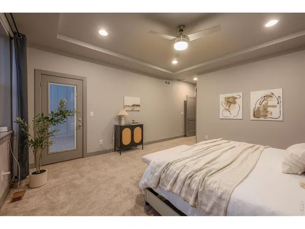 a bedroom with a large bed and a large window