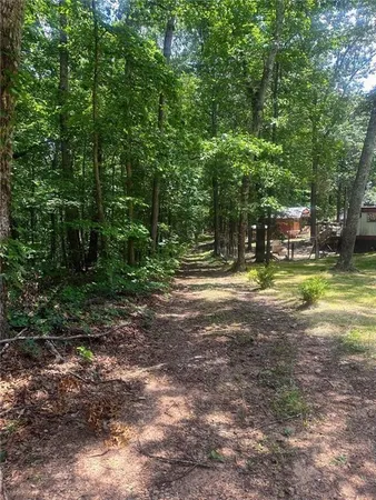 a view of a house with yard and swimming area