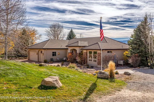 a backyard of a house with yard fire pit and outdoor seating