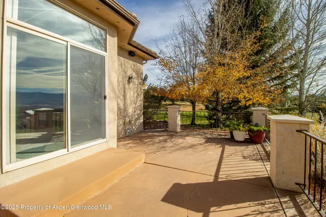 a view of a lake with a bench and trees around