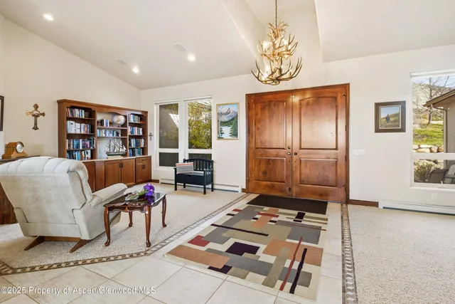 a living room with furniture fireplace and flat screen tv