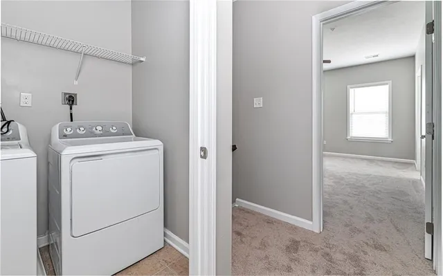 a view of storage and utility room with washer and dryer