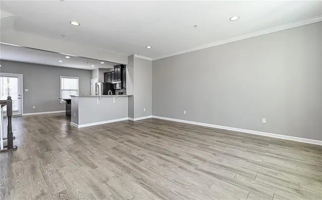 a view of a kitchen with wooden floor and a sink