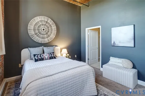 a bedroom with bed and a chair