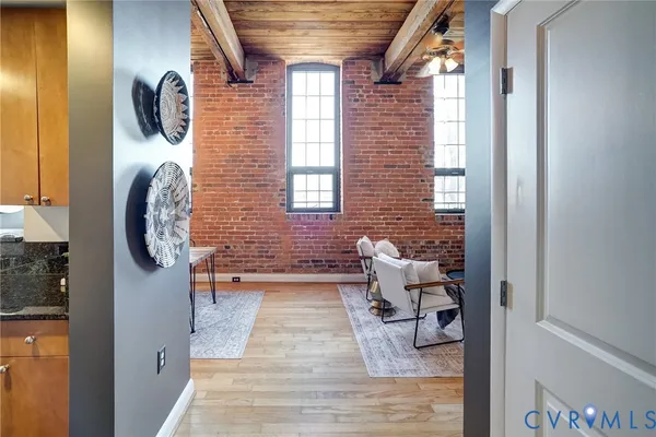 a view of entryway and hall with wooden floor
