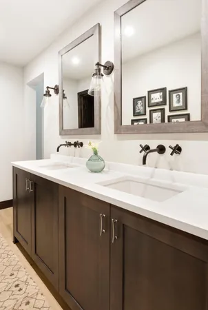 a bathroom with a double vanity sink and mirror