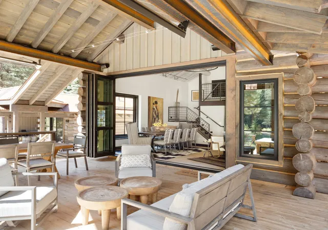 a dining room with furniture a chandelier and wooden floor