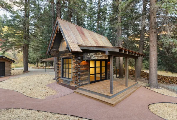 a view of a house with a balcony and wooden fence