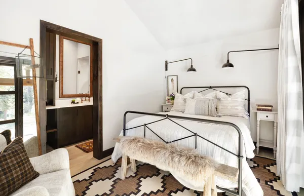 a bedroom with a bed and a mirror