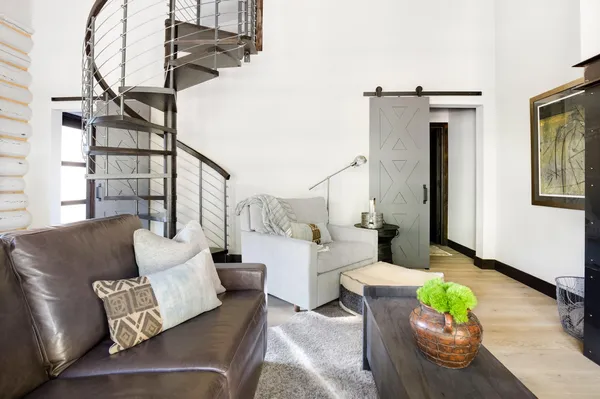 a living room with furniture and a painting on the wall