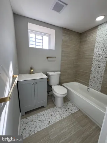 a bathroom with a sink a toilet and bathtub