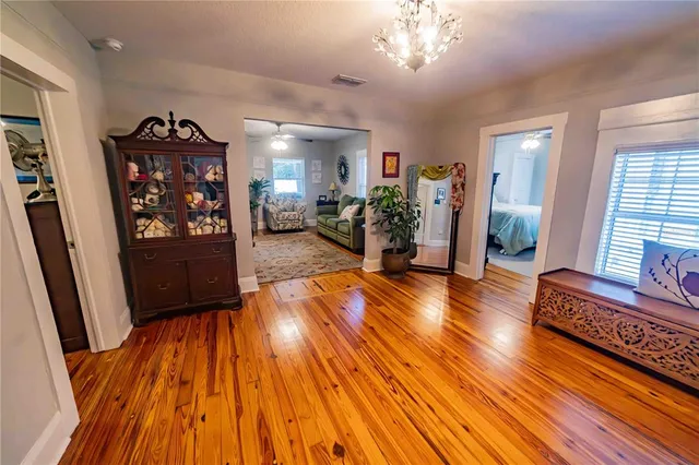 a view of a livingroom with furniture hardwood floor and a ceiling fan