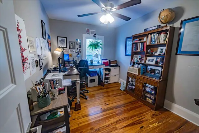 a view of a workspace with furniture and wooden floor