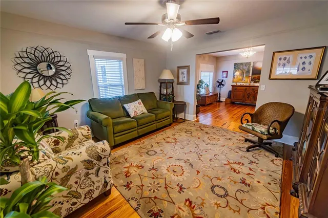 a living room with furniture a couch and a chandelier