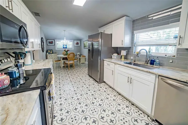a kitchen with refrigerator and window
