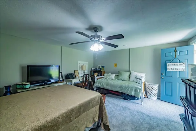 a bedroom with furniture and a flat screen tv