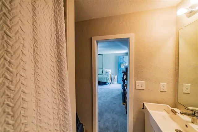 a en suite bathroom with a sink and a mirror