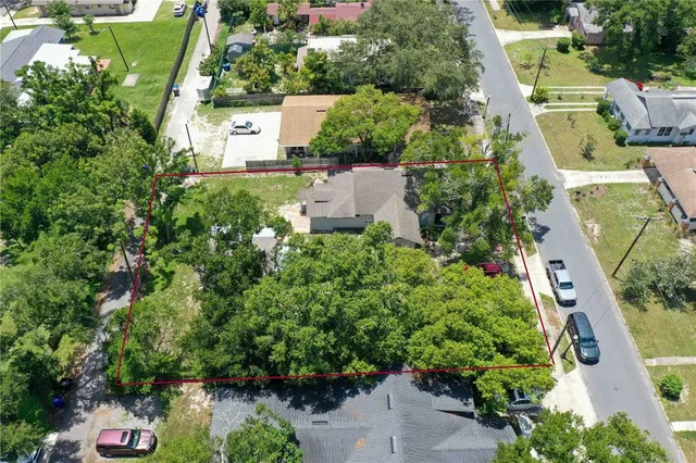 an aerial view of a house with a yard basket ball court and outdoor seating
