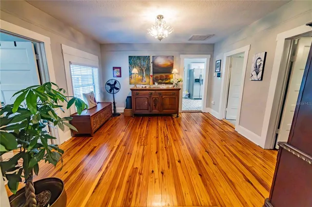 a living room filled with furniture and a wooden floor