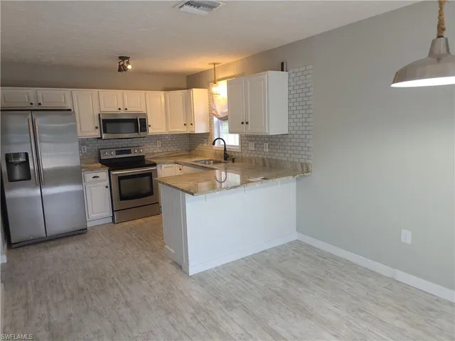 a kitchen with a sink stove and refrigerator