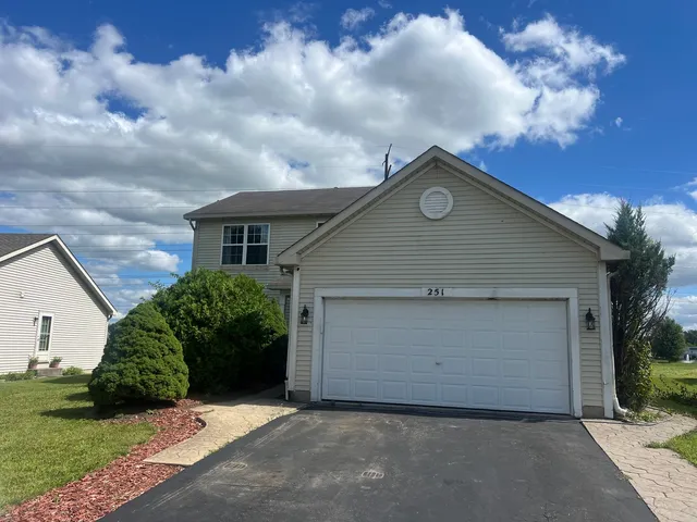 a front view of house with yard and trees
