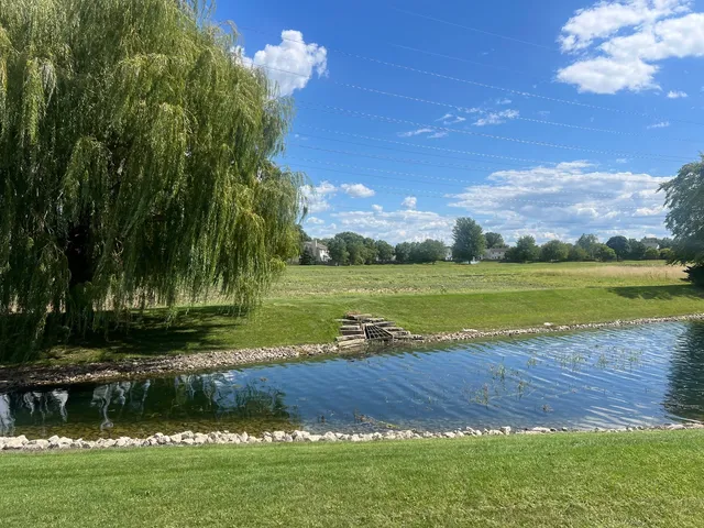 a view of a lake with houses in the background