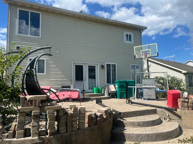 a front view of a house with outdoor seating