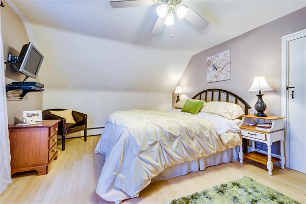 4 Old Providence Road Sutton, MA 01590 - Photo 15 of 30 a bedroom with a bed and a chandelier