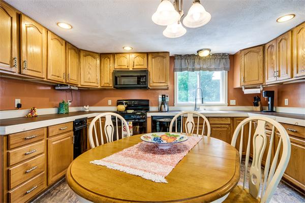 4 Old Providence Road Sutton, MA 01590 - Photo 7 of 30 a kitchen with stainless steel appliances granite countertop a sink a stove a dining table and chairs