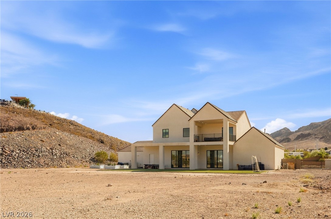 324 Wanda Road Henderson, NV 89002 - Photo 63 of 96 A classic stucco exterior rises against a backdrop of rugged desert mountains.