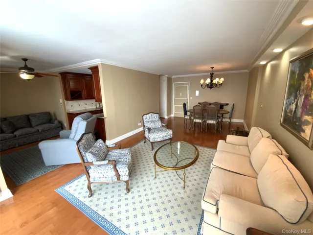 a living room with furniture and a dining table