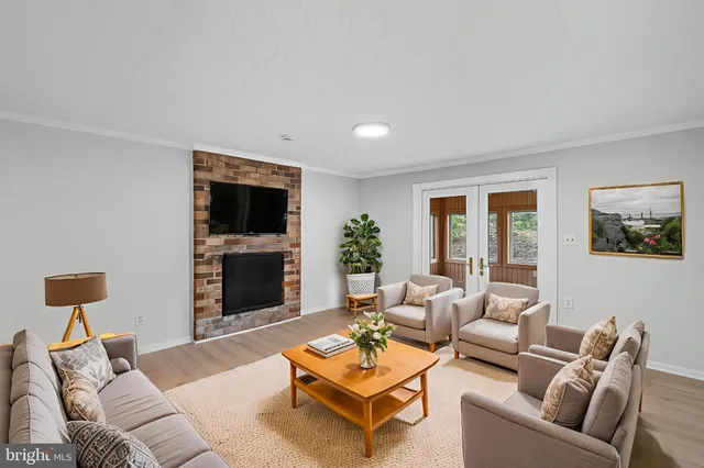 wooden floor fireplace and natural light in room