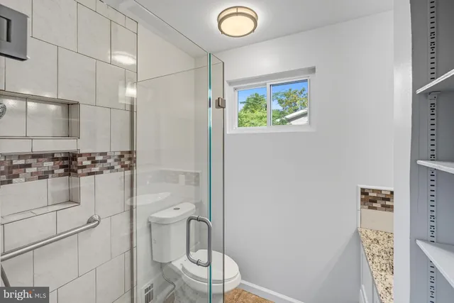 a view of a room with wooden floor and a staircase