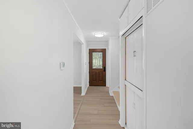 a view of a hallway with wooden floor