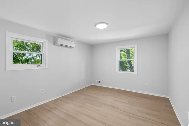 a view of a room with wooden floor