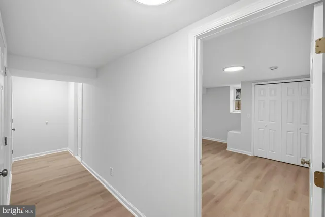 a view of a hallway with wooden floor