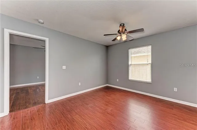 wooden floor in an empty room with a window