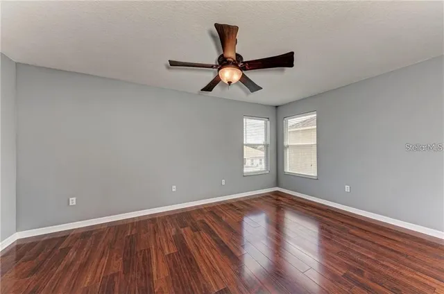 wooden floor in an empty room with a window