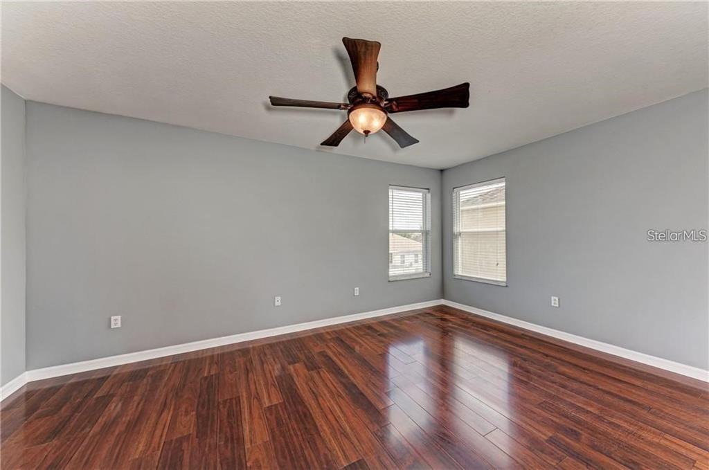 10267 Newminster Loop Ruskin, FL 33573 - Photo 15 of 38 wooden floor in an empty room with a window