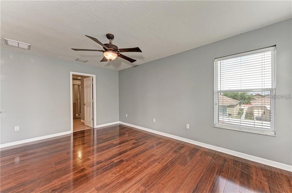 10267 Newminster Loop Ruskin, FL 33573 - Photo 16 of 38 a view of an empty room with window and wooden floor