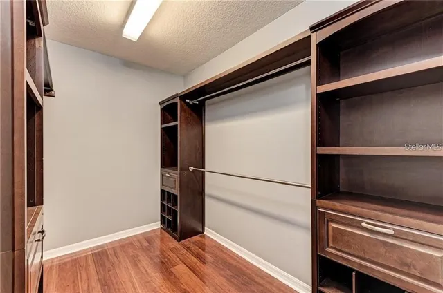 a view of walk in closet with empty racks