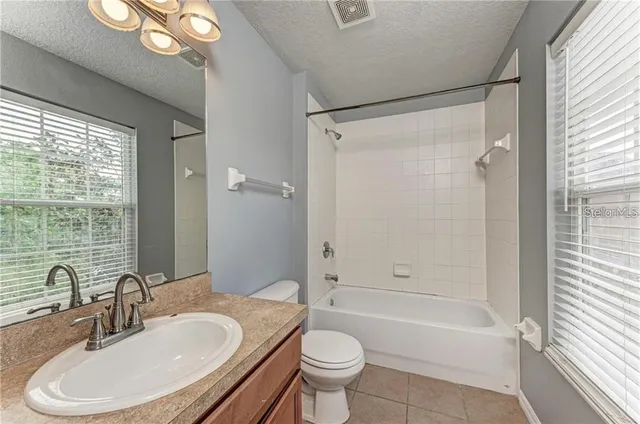 a bathroom with a sink a toilet and a bathtub