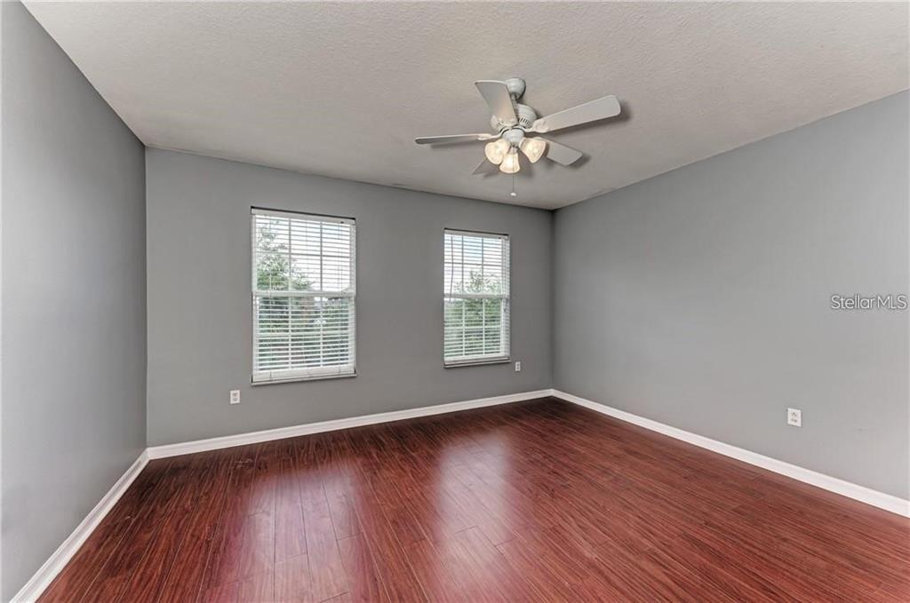 10267 Newminster Loop Ruskin, FL 33573 - Photo 24 of 38 a view of an empty room with wooden floor and a window