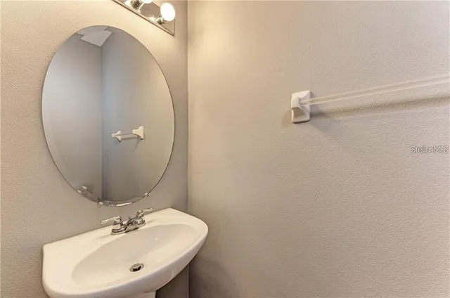 a bathroom with a sink and mirror