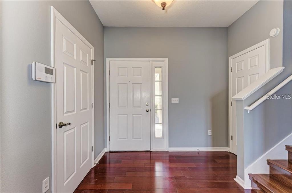 10267 Newminster Loop Ruskin, FL 33573 - Photo 27 of 38 a view of a hallway with wooden floor
