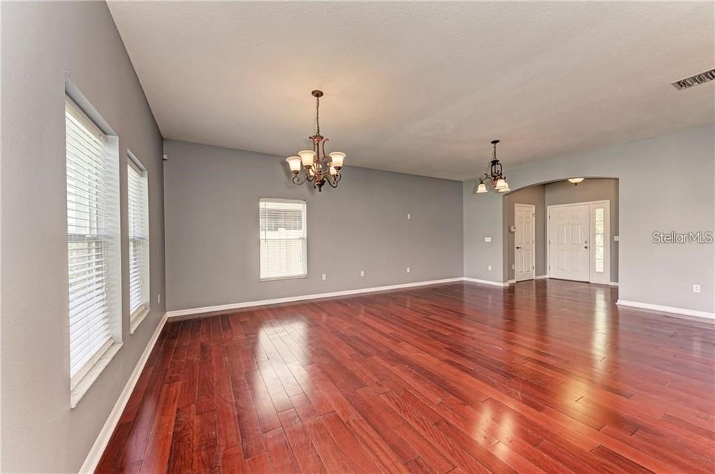 10267 Newminster Loop Ruskin, FL 33573 - Photo 30 of 38 a view of empty room with wooden floor and window