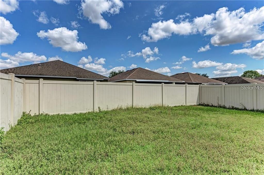 10267 Newminster Loop Ruskin, FL 33573 - Photo 32 of 38 a view of a backyard with potted plants